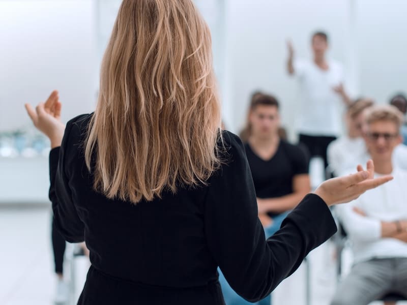 estudiante de preparatoria haciendo una exposición frente a su salón